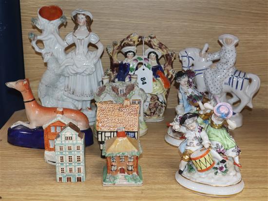 A small collection of Staffordshire figures, groups and cottages, two Sitzendorf figural groups, a Rye lady on horseback, etc.